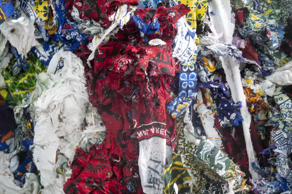 Collected small pieces of African printed textile waste from Ghana for recycling and textile waste management.